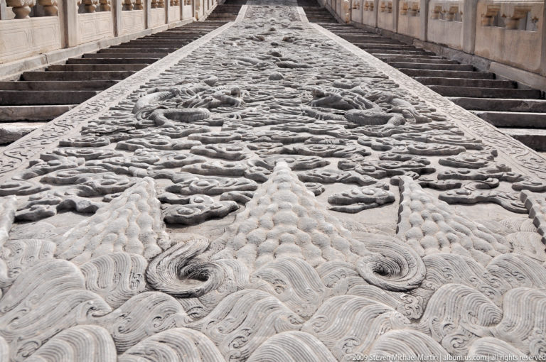 Axial view up the dragon-carved central stone ramp flanked by ceremonial stairways in the Forbidden City.