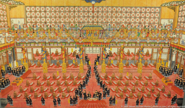 Court painting of an imperial ceremony in a symmetrical palace interior with ranks of officials and attendants.