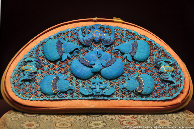 Semicircular blue embroidered panel decorated with five bats and a central auspicious emblem.