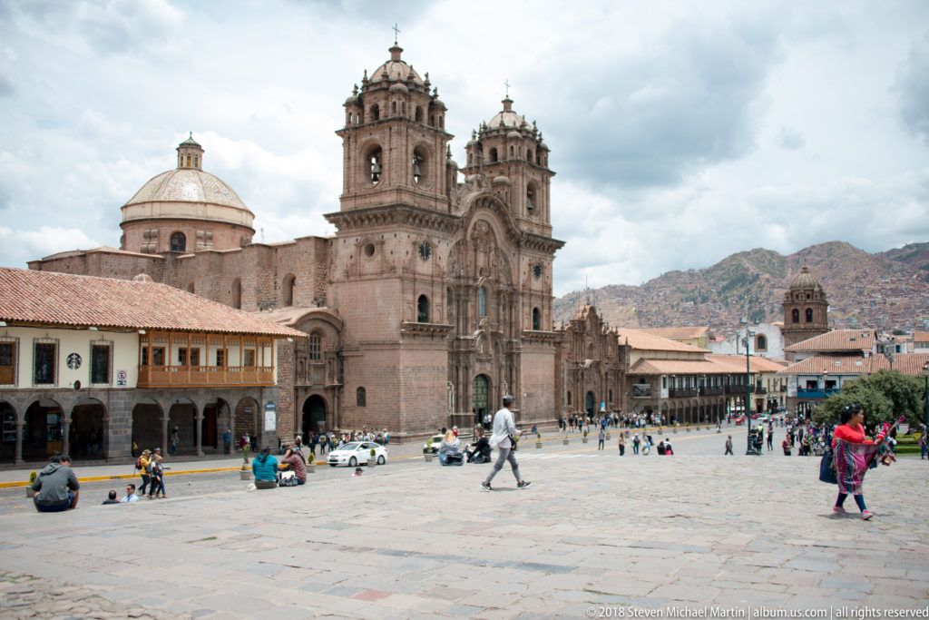 Twin-towered Church of the Society of Jesus facing the Plaza de Armas, with its dome visible to the left.