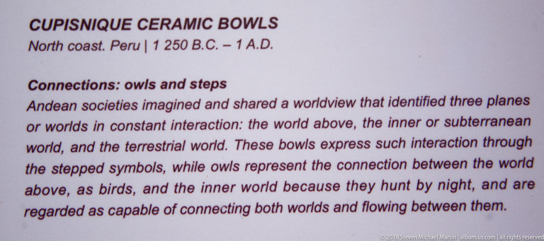 Museum panel explaining Andean ceramic bowls with stepped symbols and owls connected to upper, subterranean, and terrestrial worlds.