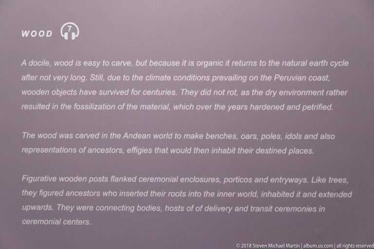 Museum text panel discussing preservation of wood and carved Andean objects including benches, oars, idols, ancestor figures, and ceremonial posts.