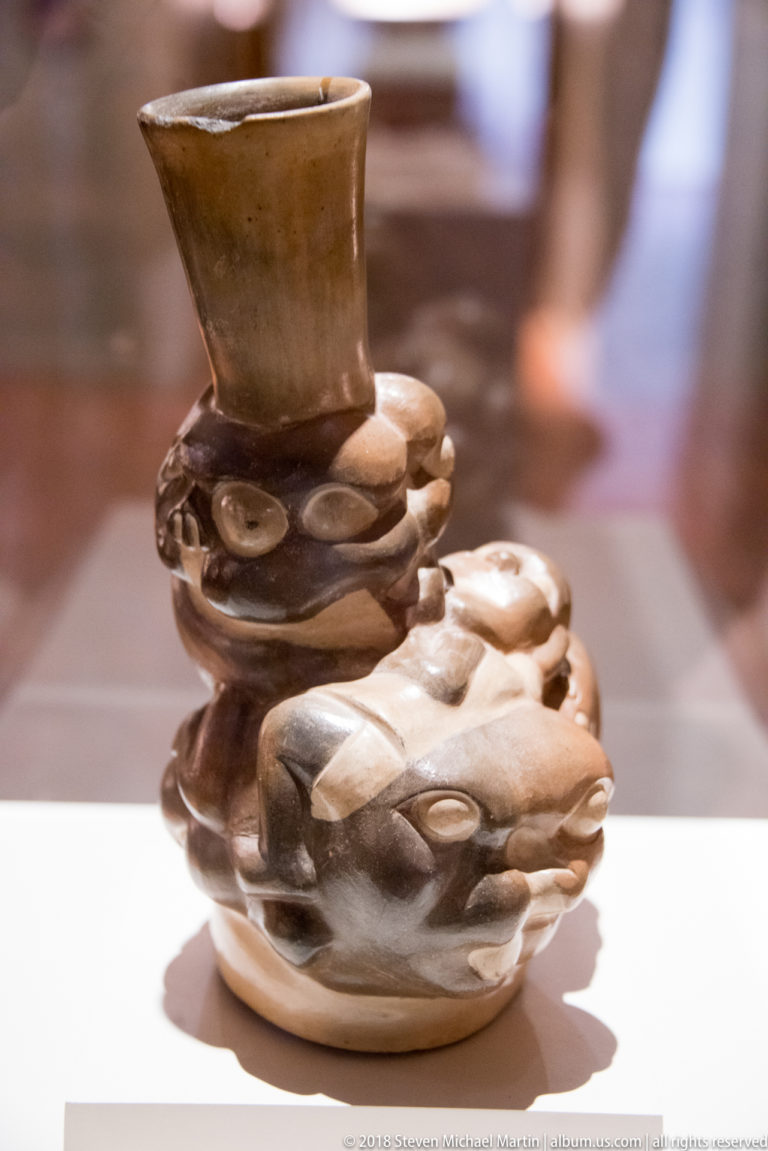 Mochica sculptural ceramic vessel composed of stacked human and animal-like modeled forms.