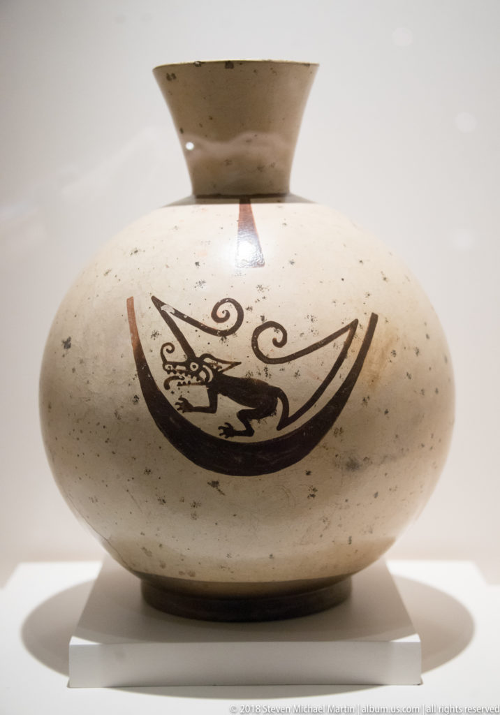 Globular Mochica ceramic bottle painted with the museum-identified lunar-animal motif.