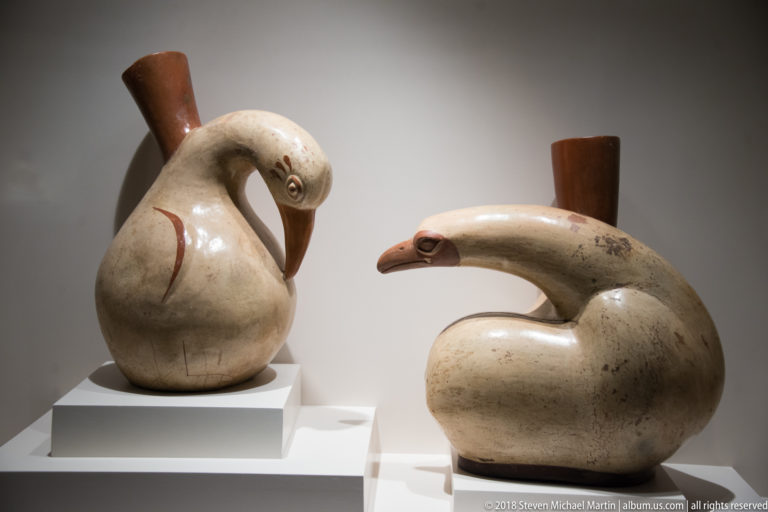 Two Mochica ceramic bird-effigy bottles with rounded bodies, modeled heads, and prominent beaks.