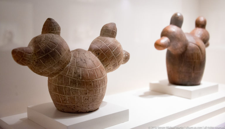 Pair of rounded Mochica ceramic animal-effigy vessels with projecting heads and incised surface patterns.