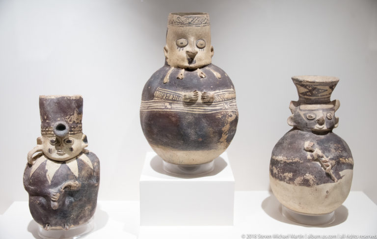 Three globular pre-Columbian ceramic vessels modeled as standing human figures with faces, headdresses, arms, and painted details.