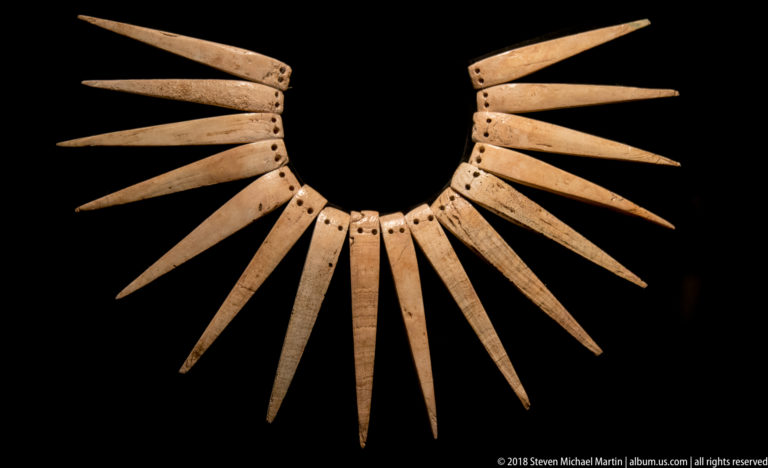 Radiating pre-Columbian collar made of many tapered pale shell pendants drilled at the top and arranged like spikes.