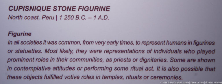 Interpretive panel for a Cupisnique stone figurine, discussing human statuettes, priests or dignitaries, and possible votive or ritual functions.
