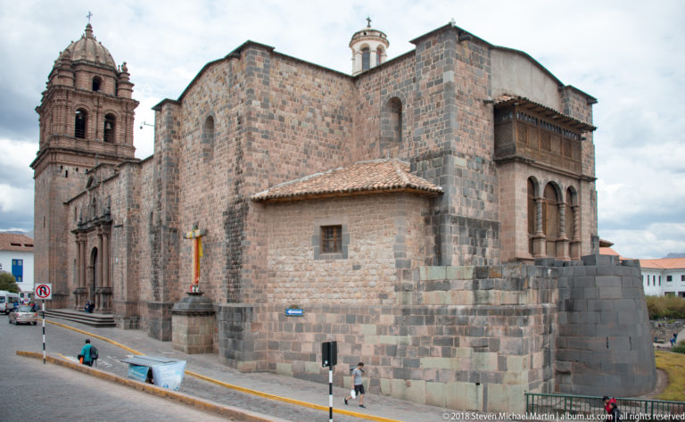 Exterior of the Church and Convent of Santo Domingo rising above dark Inca stonework at Qorikancha.