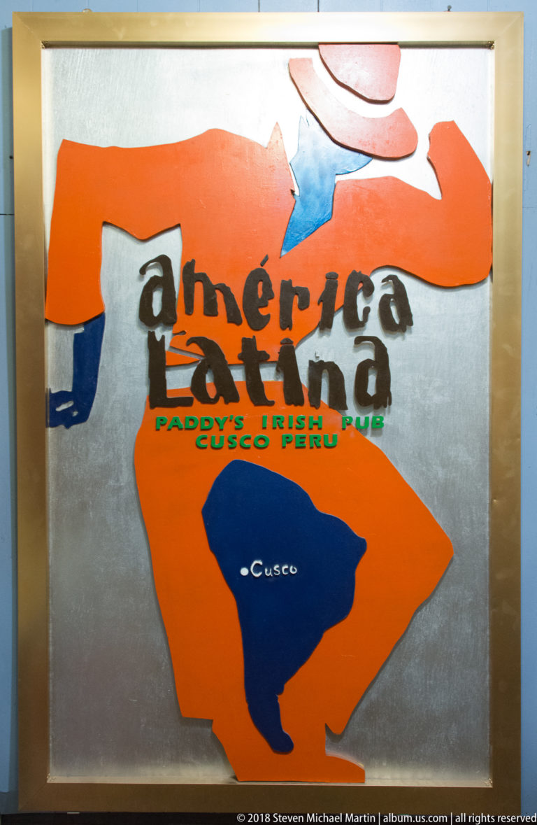 Colorful Inka Grill sign with stylized figure, South America silhouette, and reference to Paddy’s Irish Pub in Cusco.