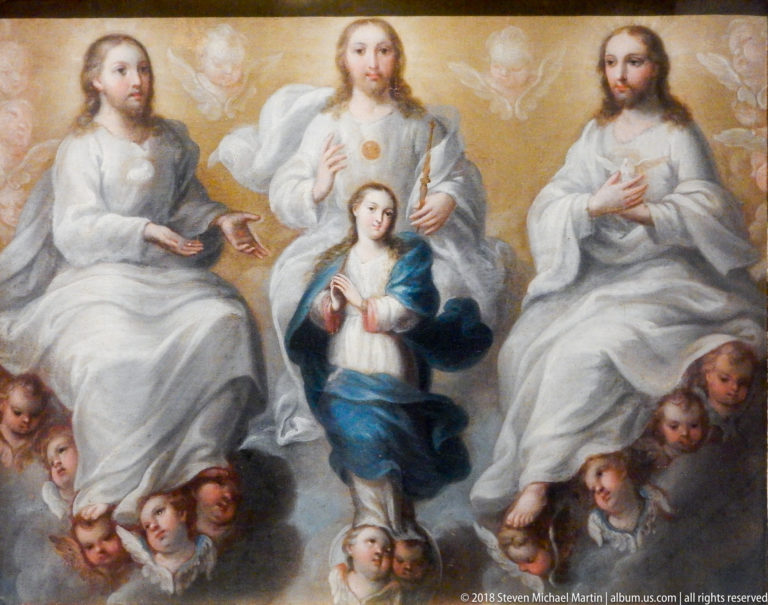 Virgin in white and blue stands amid cherub heads beneath seated heavenly figures in a luminous religious painting.