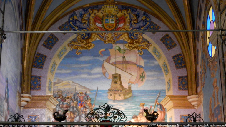 Arched mural of a sailing ship approaching a coastal tower as figures gather along the shore, beneath heraldic decoration.