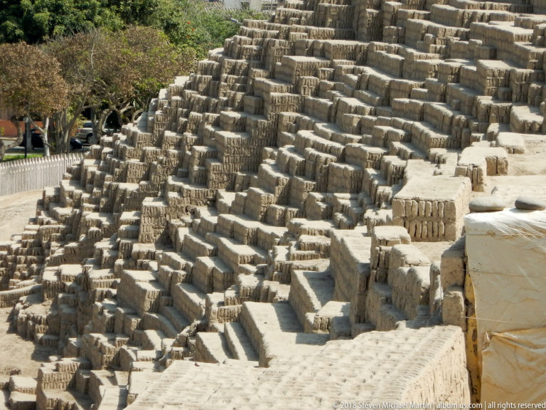 High-angle view across dense stepped adobe terraces and walls forming a maze-like section of Huaca Pucllana.