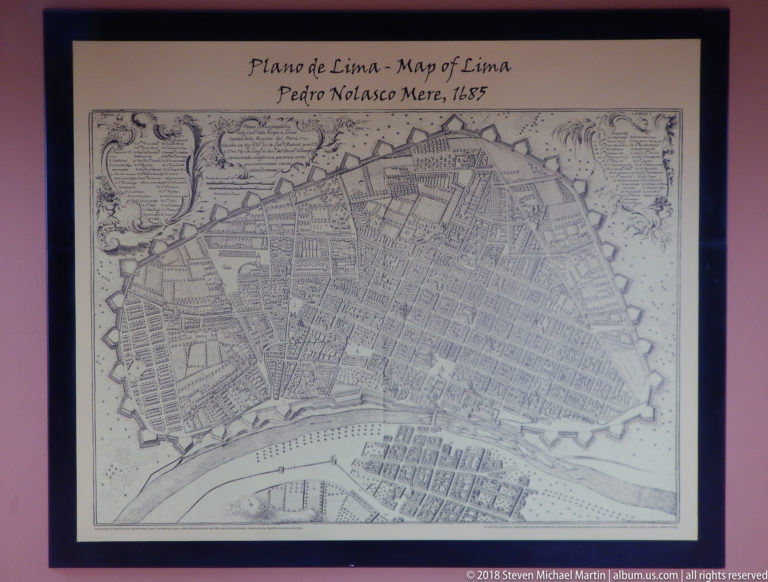 Framed 1685 plan of Lima showing the walled city, street grid, gates, labels, and river along the lower edge.