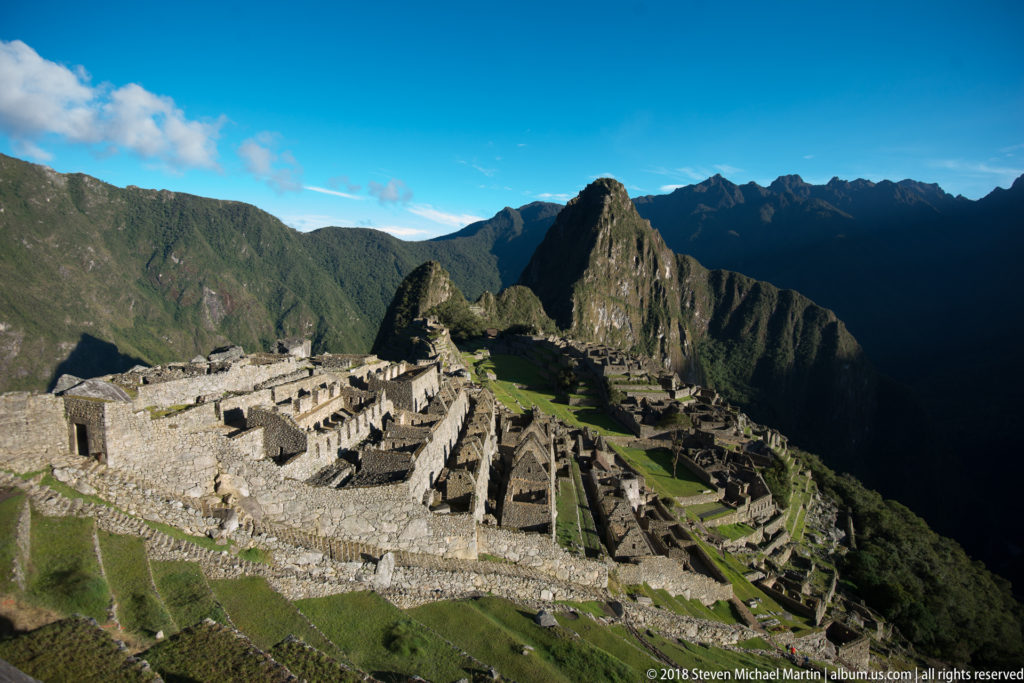 Broad panorama of Machu Picchu’s masonry, lawns, and terraces beneath Huayna Picchu.