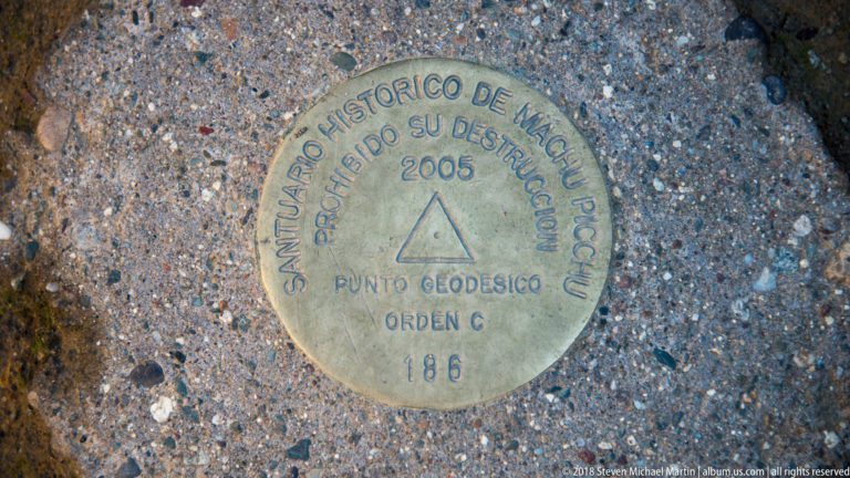 Round metal geodetic marker for the Santuario Histórico de Machu Picchu, dated 2005 and numbered 186.