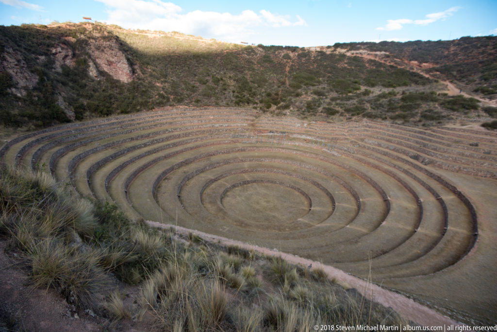High view of Moray's near-circular concentric terraces descending in repeated rings to a round central floor.