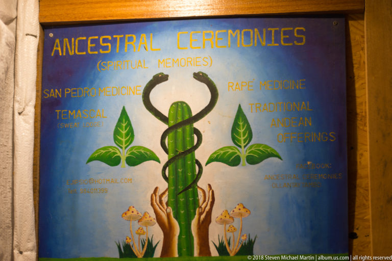 Painted “Ancestral Ceremonies” sign listing San Pedro, rapé, temazcal, and traditional Andean offerings.