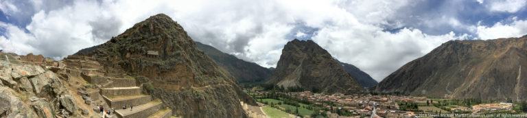 Panoramic view of Machu Picchu ruins and terraces with Huayna Picchu rising beyond the citadel.