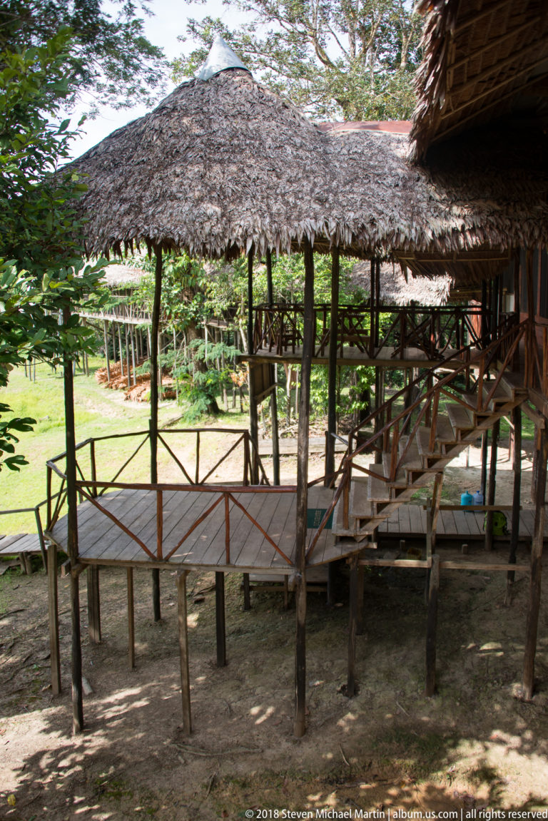 Raised thatched connector and stairs at Tuhauyo Lodge.