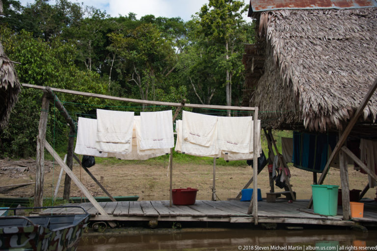 Laundry drying beside thatched building at Tuhauyo Lodge.