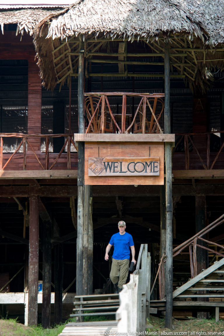 Raised timber façade with welcome sign at Tuhauyo Lodge.