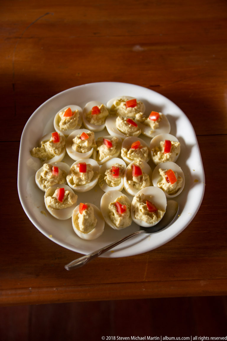 Halved eggs with creamy filling and red garnish at Tuhauyo Lodge.