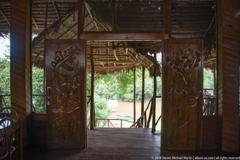 Decorative carved timber entrance panels at Tuhauyo Lodge.