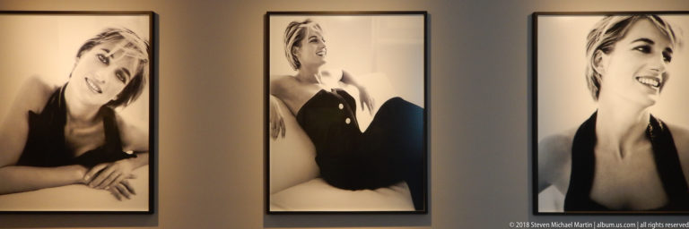 Three tall black-and-white portraits of Diana, Princess of Wales, displayed side by side on a gallery wall.