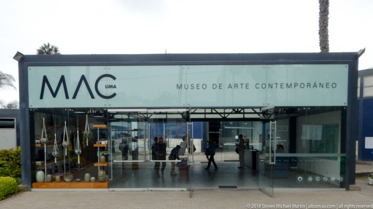 MAC Lima entrance with Museo de Arte Contemporáneo signage above wide glass doors and visitors visible inside.
