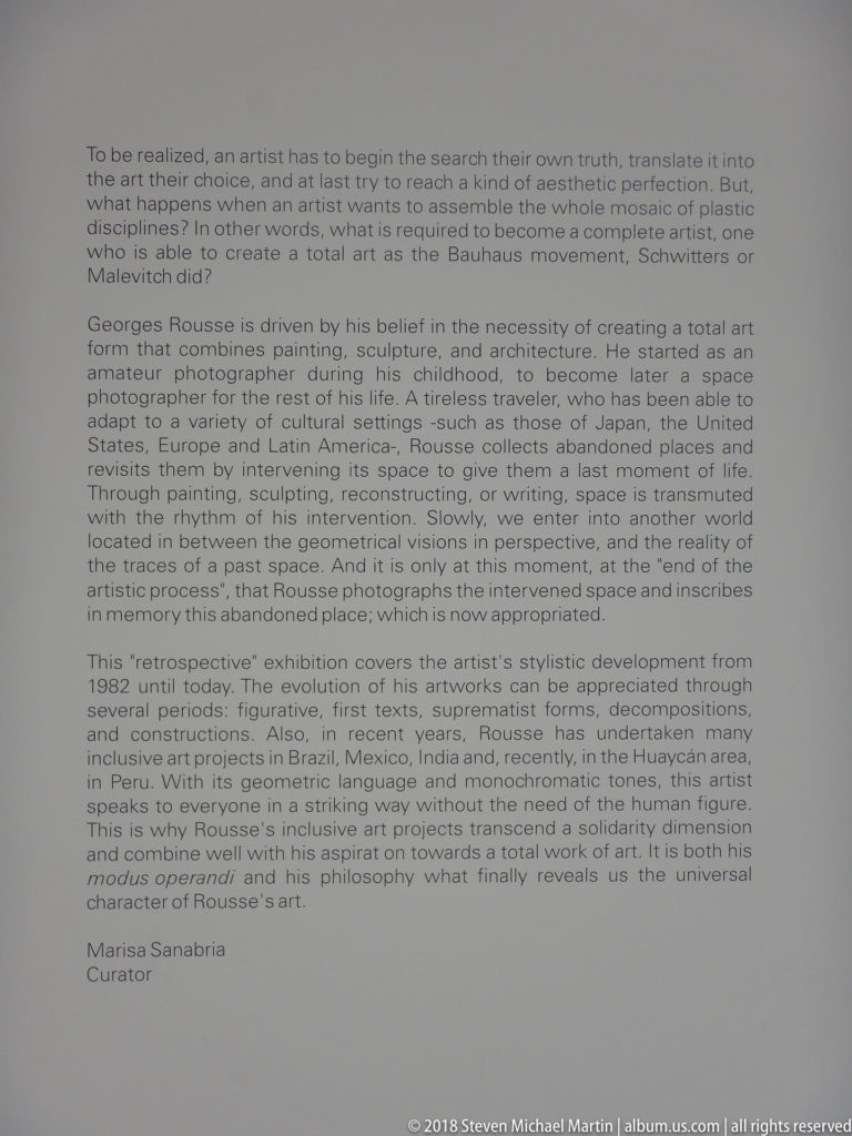 Curatorial wall label with English text about artist Georges Rousse and his site-specific photographic and architectural practice.