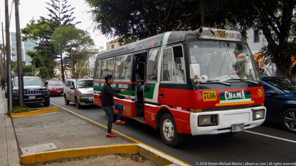 Red, green, and white city bus numbered 8606 at the curb as a passenger approaches the open door.