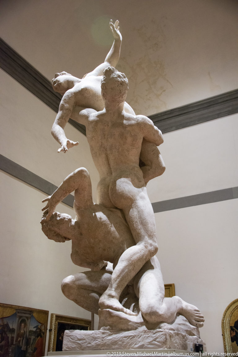 Alternate low-angle view of intertwined nude figures, including a kneeling lower figure and an upper figure reaching backward.