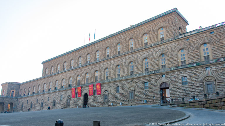Rusticated stone exterior of Pitti Palace with repeated windows and strongly modeled masonry.