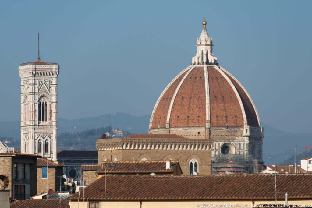 Brunelleschi’s red-tiled cathedral dome and Giotto’s Campanile rising above the rooftops of Florence.