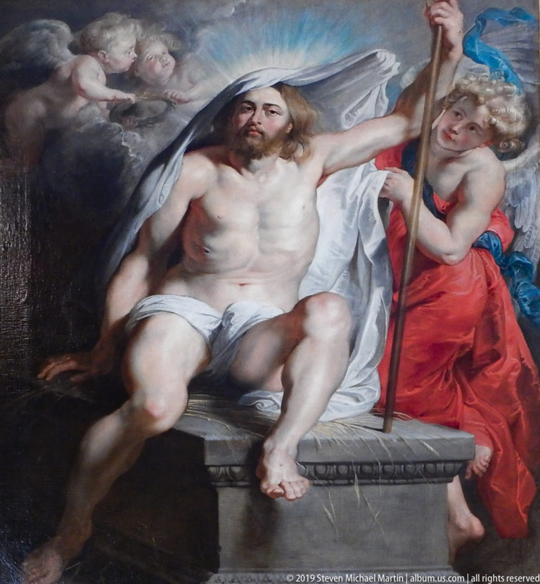 Large framed or ceiling painting with multiple figures in a richly decorated Pitti Palace interior.