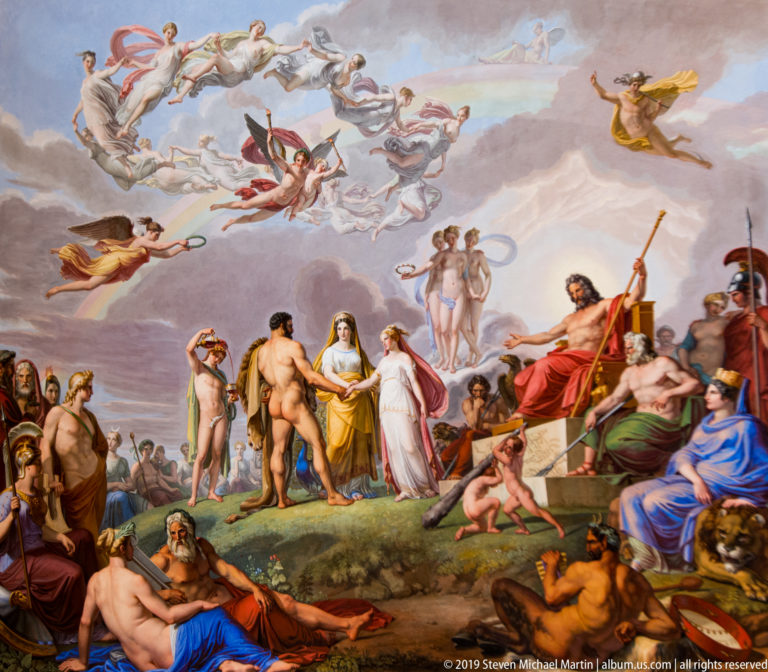 Large framed or ceiling painting with multiple figures in a richly decorated Pitti Palace interior.