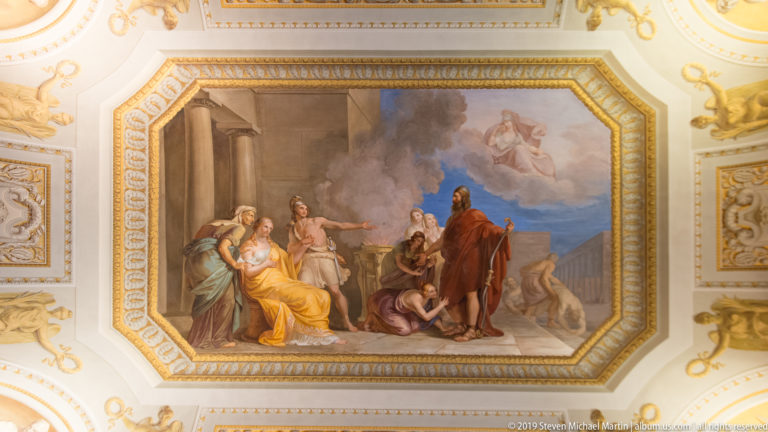 Octagonal ceiling painting of robed classical figures in an architectural setting, with smoke and an airborne figure above.