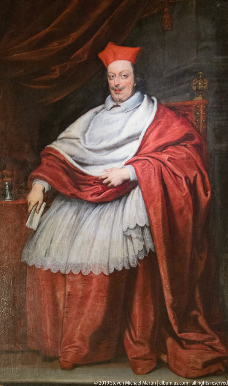 Painted portrait of a seated cardinal wearing a red skullcap and robes over a white surplice, posed against a dark background.