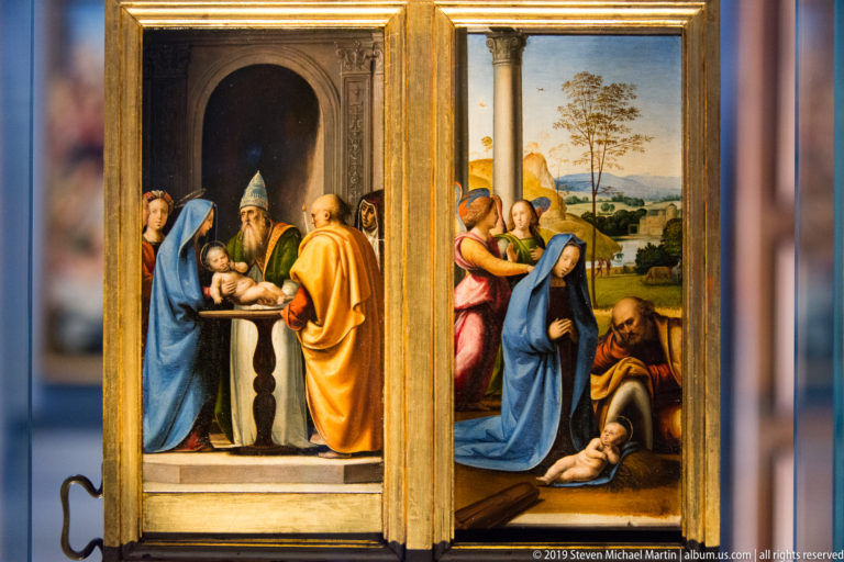 Small gilded two-panel painting with religious scenes centered on an infant, figures, architecture, and landscape.