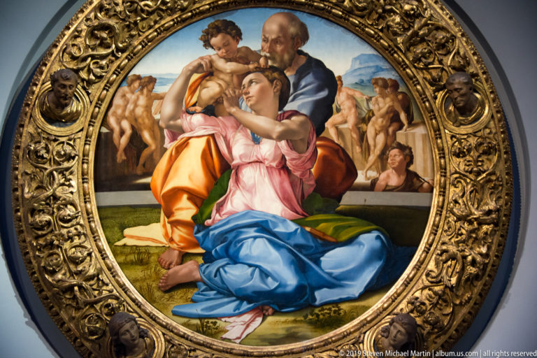 Michelangelo’s Doni Tondo, with Mary twisting toward the Christ Child and Joseph before a background of youthful nude figures.