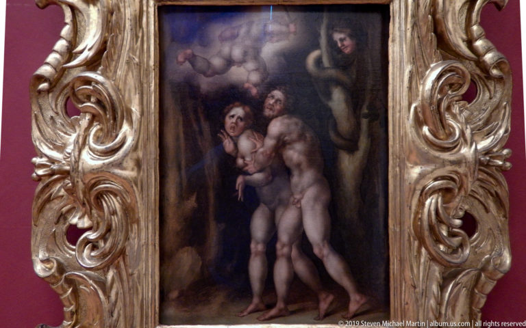 Dark vertical painting of several nude figures surrounded by a heavily carved gilded frame.
