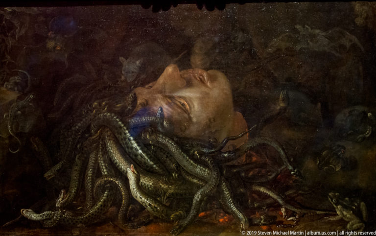Severed head of Medusa surrounded by writhing snakes in a dark setting, an early seventeenth-century Flemish composition.