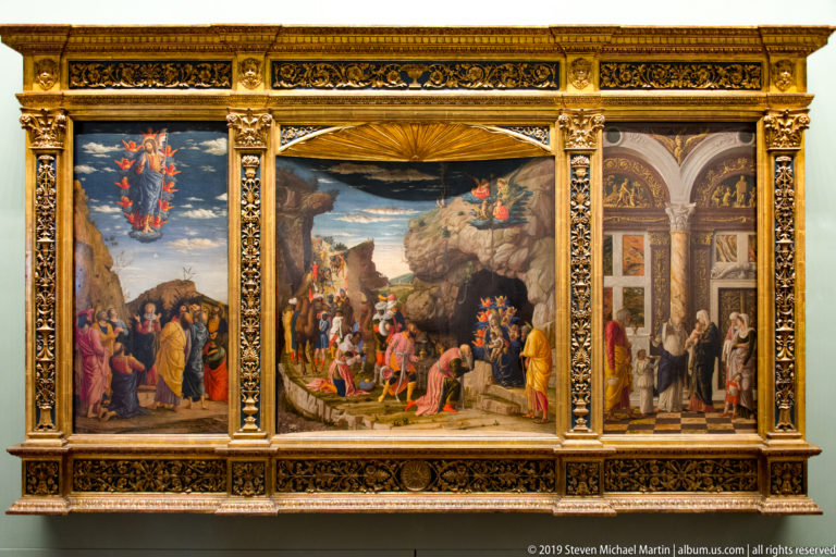 Three Renaissance narrative paintings arranged as a triptych within an elaborate gilded frame with carved columns.
