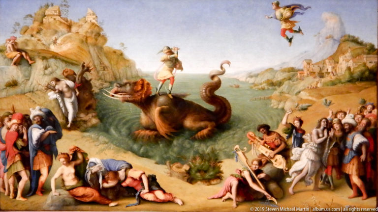 Fantastic sea monster rises from coastal water as crowds react on both shores and figures confront it from above.