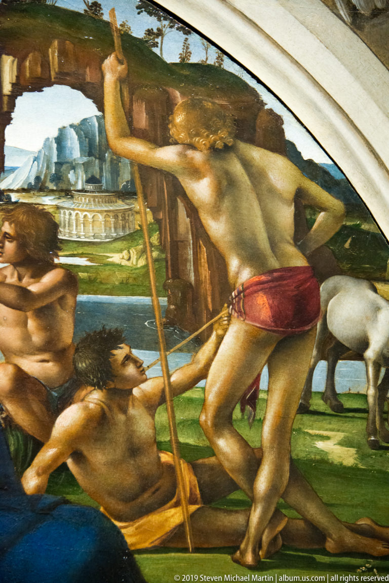 Detail of several nude men struggling outdoors, including a standing figure bracing a long staff.