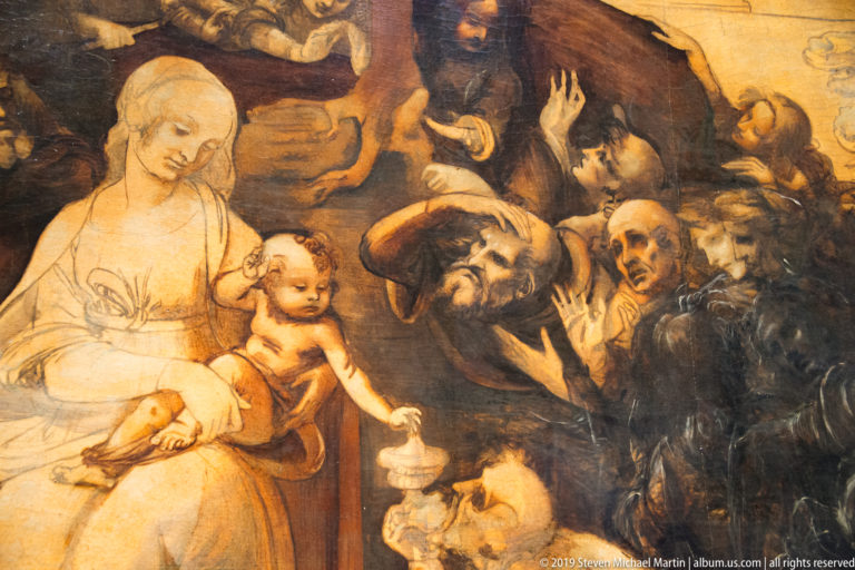 Central detail of Leonardo’s unfinished Adoration of the Magi with the Virgin and Child surrounded by expressive male figures.