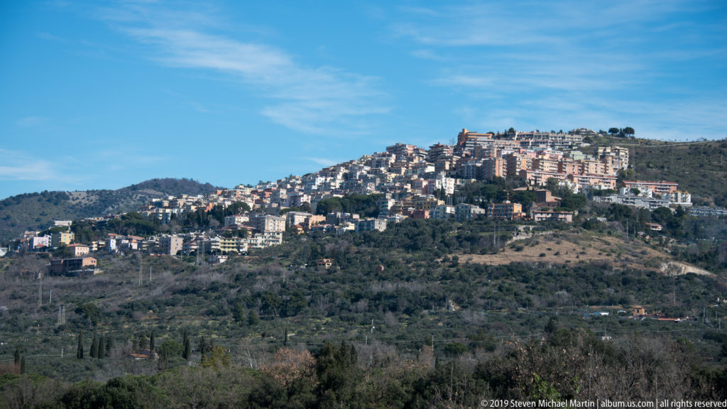 Distant hillside town of Tivoli above wooded and open countryside seen from the archaeological site.