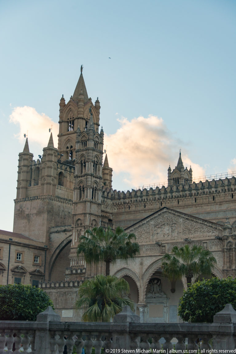 Palermo Cathedral’s towers and arched façade stand against a pale evening sky.